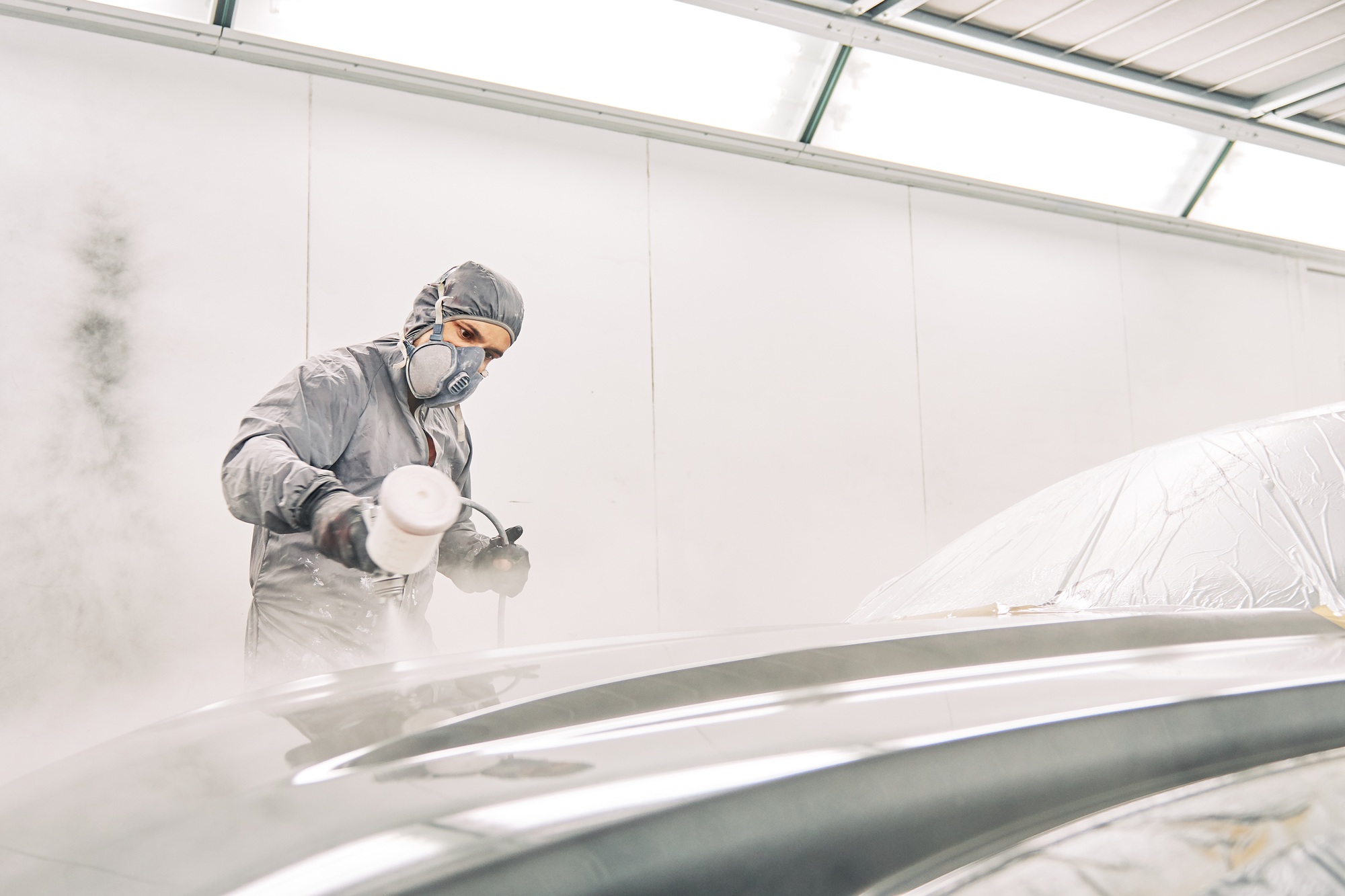 A man painting a car